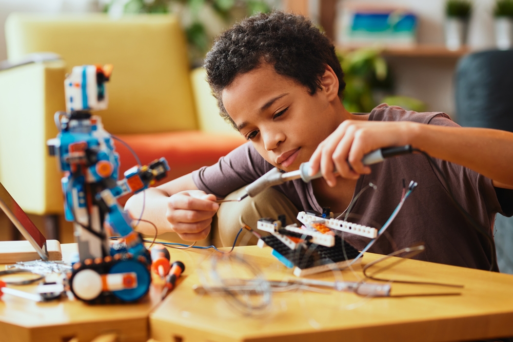 Smart,African,Boy,Making,A,Robot,At,Home,For,Science Smart,African,Boy,Making,A,Robot,At,Home,For,Science